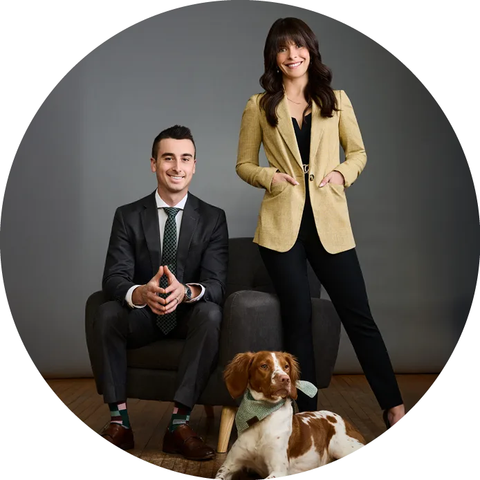 Phil, Lee-Ann, and their dog posing in a photography studio.